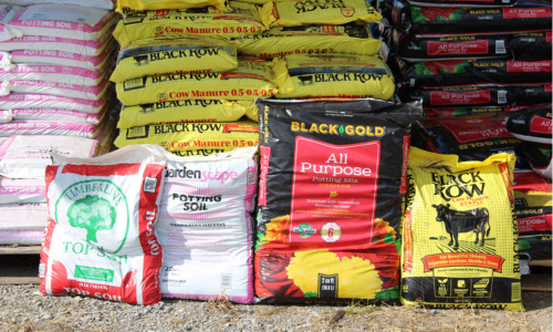 Bags of topsoil displayed outside of Rudy's Farm.
